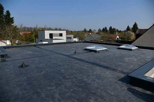 An image of EPDM roofing systems been installed on the flat roof